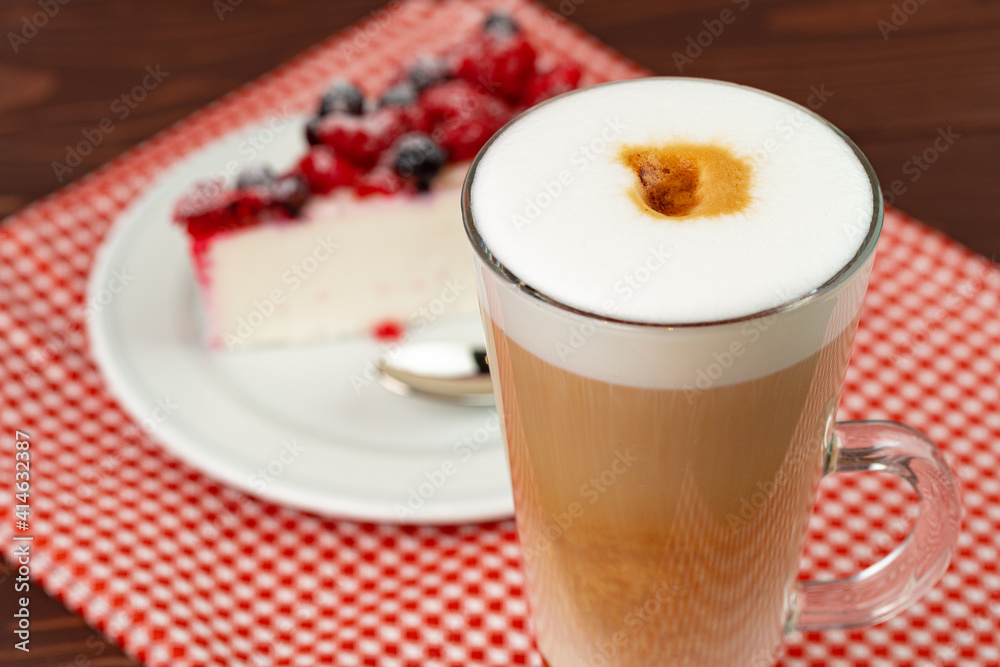 Cup of latte coffee with piece of berry cheesecake Cup of latte coffee with piece of berry cheesecake