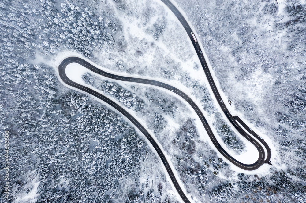 Winter snow winding road Serpentine Switchbacks forest woods season aerial photo view