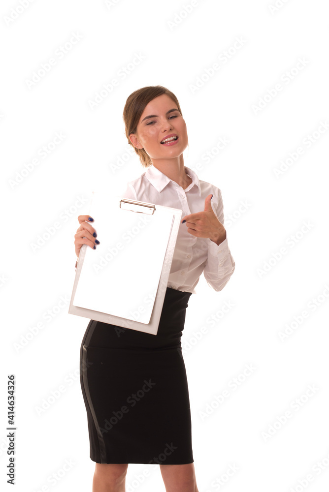 Young girl posing at camera with blank tablet in hands. Girl in office clothes stands with an empty tablet in her hands. Young girl posing at camera with blank tablet in hands. Girl in office clothes stands with an empty tablet in her hands.