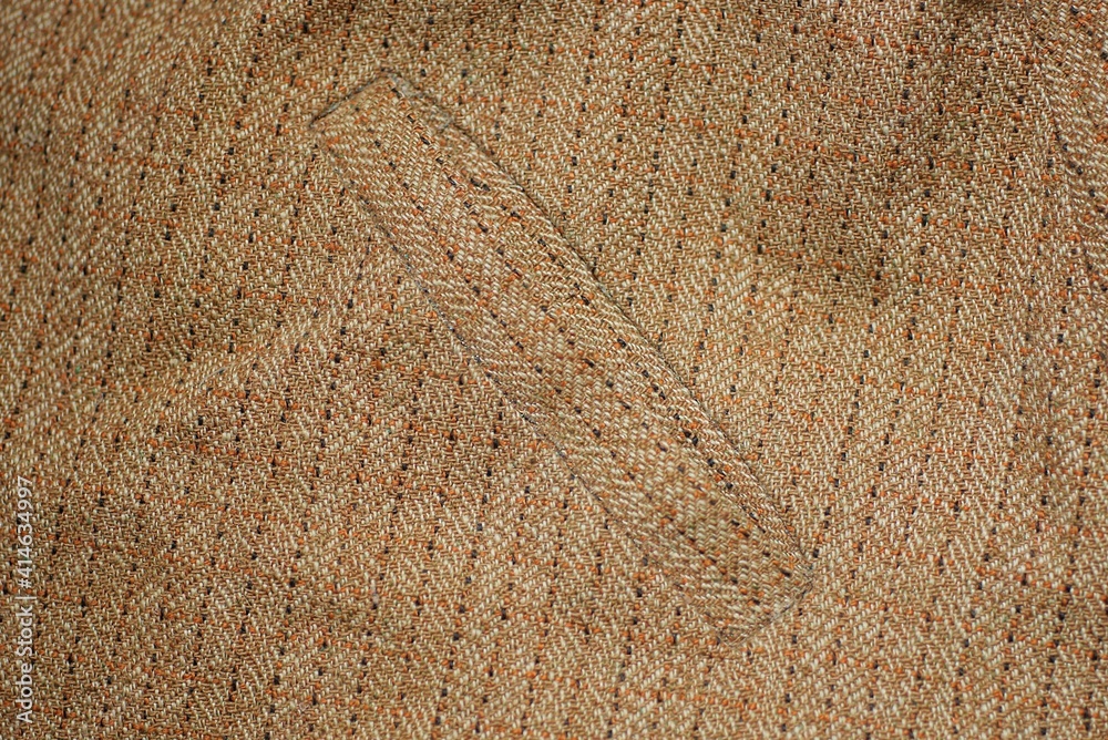 Fototapeta premium brown texture from a piece of woolen cloth with a stripe and pocket
