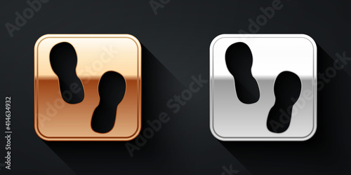 Gold and silver Human footprints shoes icon isolated on black background. Shoes sole. Long shadow style. Vector.