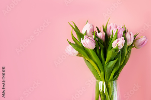 Spring Banner. A bunch of pink tulips in a vase with space for text. © piksik