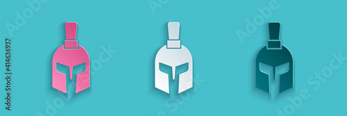 Paper cut Greek helmet icon isolated on blue background. Antiques helmet for head protection soldiers with a crest of feathers or horsehair. Paper art style. Vector.