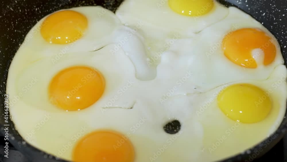 Cooking Eggs, Close-up of Fried Eggs. The Process of Frying Eggs in a Frying Pan. Cooking a Hearty and Protein-rich Breakfast. Cooking Eggs, Close-up of Fried Eggs. The Process of Frying Eggs in a Frying Pan. Cooking a Hearty and Protein-rich Breakfast.