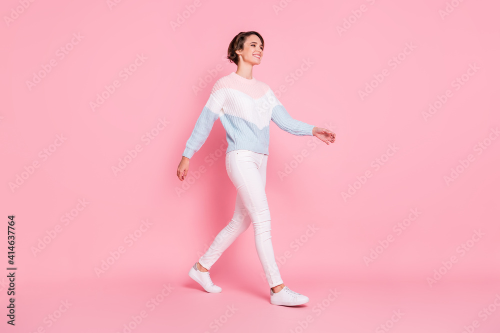 Photo portrait full body profile side view of gorgeous girl walking isolated on pastel pink colored background