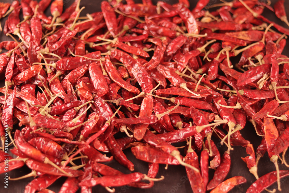 Fototapeta premium pile of dried red chili pepper as a food background with Chili pepper powder in bowl,smoked red paprika spicy with Chili powder,crushed red chili pepper with dry Red chili