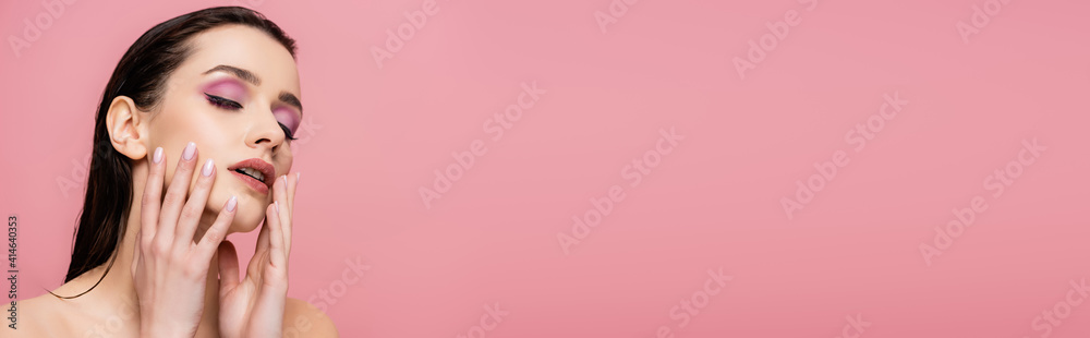 young woman with bare shoulders and makeup touching face isolated on pink, banner young woman with bare shoulders and makeup touching face isolated on pink, banner