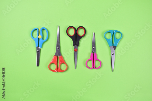 Scissors in grid on green background