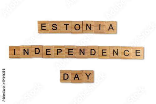 Top view of the word estonia independence day laid out from square wooden tiles isolated on white background. World and international day.