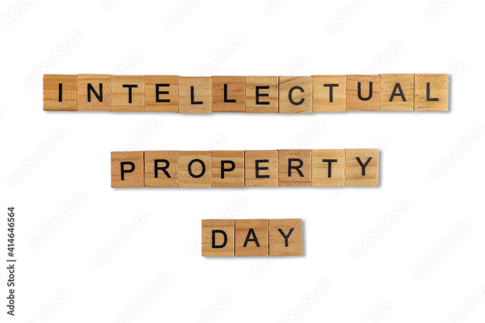 Top view of the word intellectual property day laid out from square wooden tiles isolated on white background. World and international day. Top view of the word intellectual property day laid out from square wooden tiles isolated on white background. World and international day.