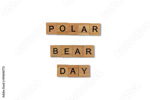 Top view of the word polar bear day laid out from square wooden tiles isolated on white background. World and international day.