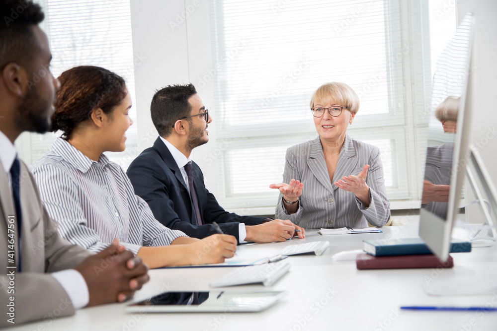 Mature businesswoman explains to colleague a new project Mature businesswoman explains to colleague a new project