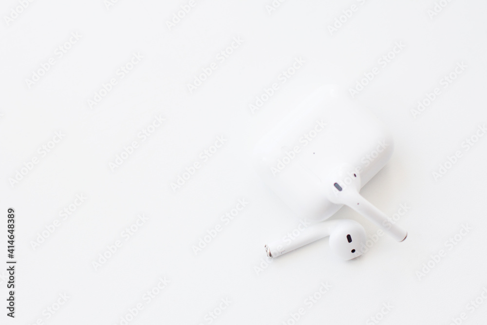Wireless headphones - in-ear with box on a white background. Modern technology concept. Wireless headphones - in-ear with box on a white background. Modern technology concept.