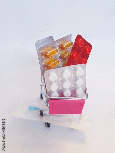 Food cart with pills on white background. Concept of medicine, treatment, use, purchase and sale of medicines.