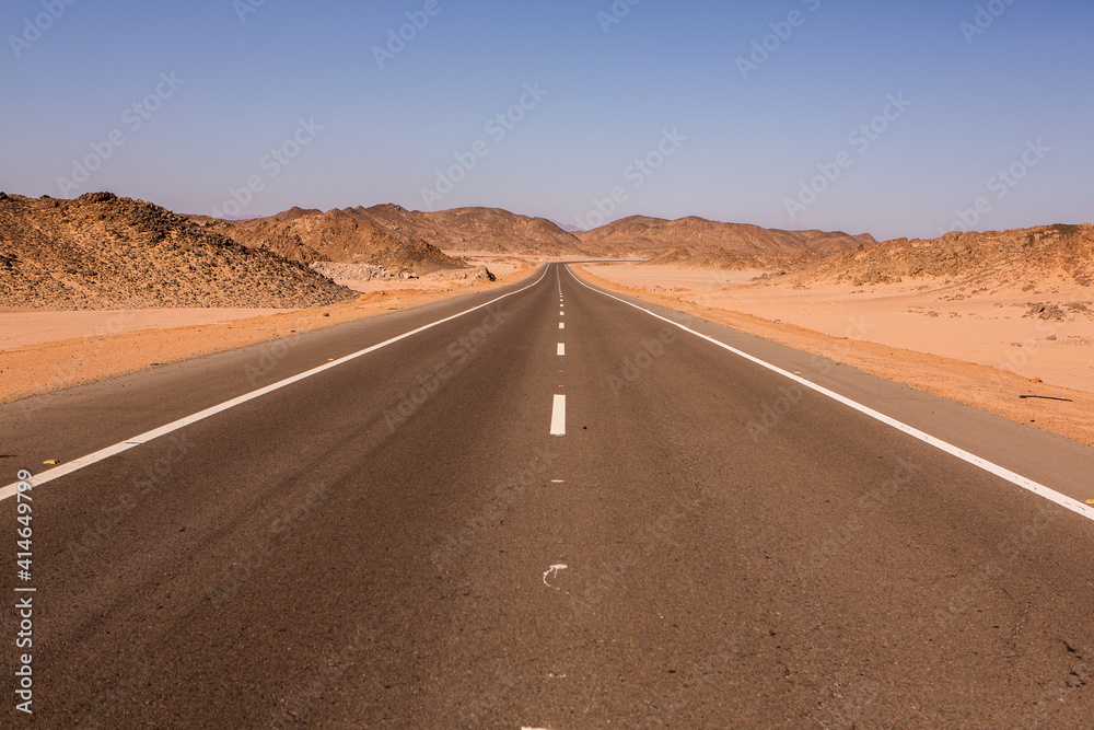 Road in the sahara desert of Egypt. Conceptual for freedom, enjoying the journey. Empty road. Freeway, Highway through the desert