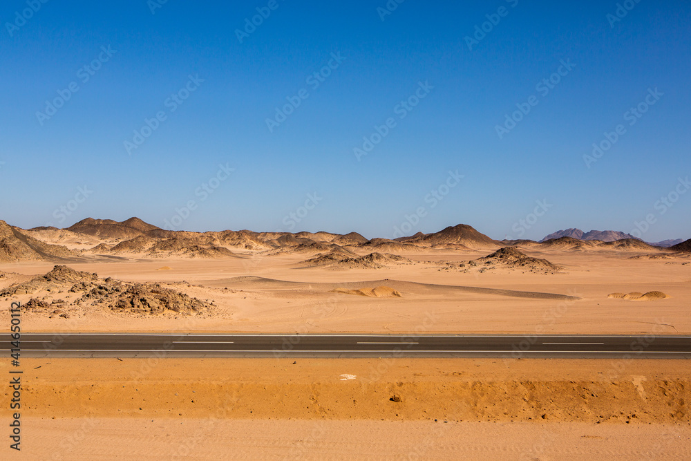 Road in the sahara desert of Egypt. Conceptual for freedom, enjoying the journey. Empty road. Freeway, Highway through the desert