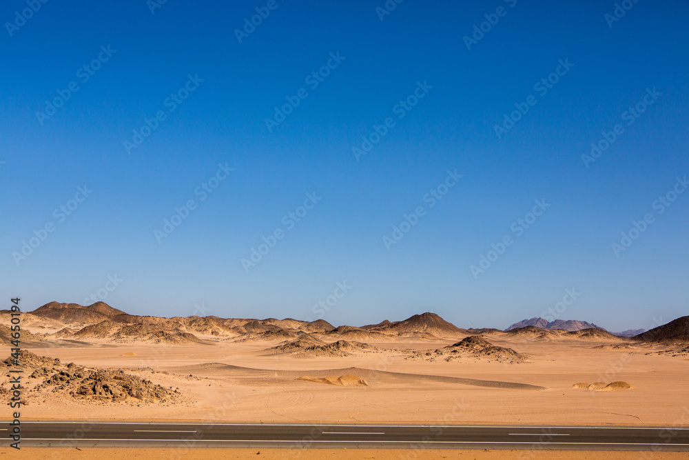 Road in the sahara desert of Egypt. Conceptual for freedom, enjoying the journey. Empty road. Freeway, Highway through the desert