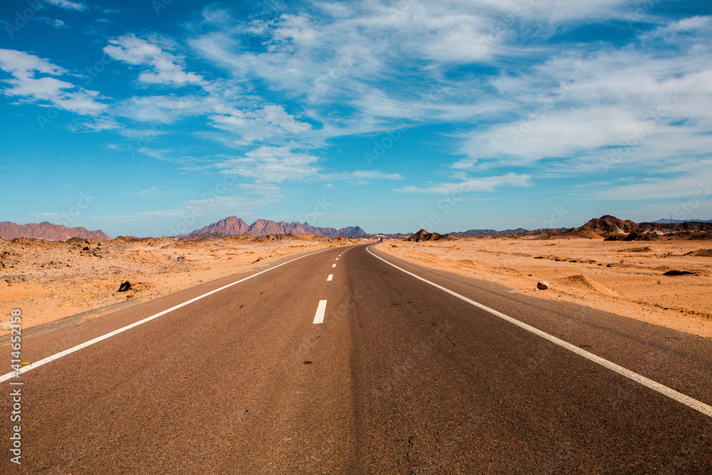 Road in the sahara desert of Egypt. Conceptual for freedom, enjoying the journey. Empty road. Freeway, Highway through the desert Road in the sahara desert of Egypt. Conceptual for freedom, enjoying the journey. Empty road. Freeway, Highway through the desert