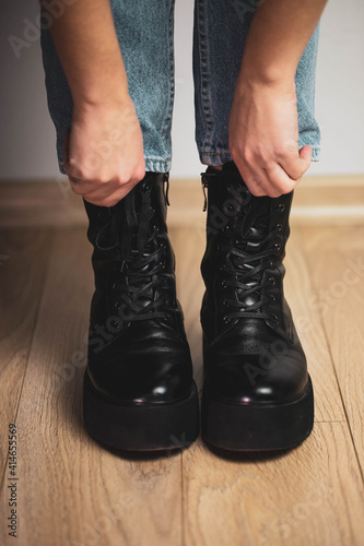 girl wearing big black boots macro
