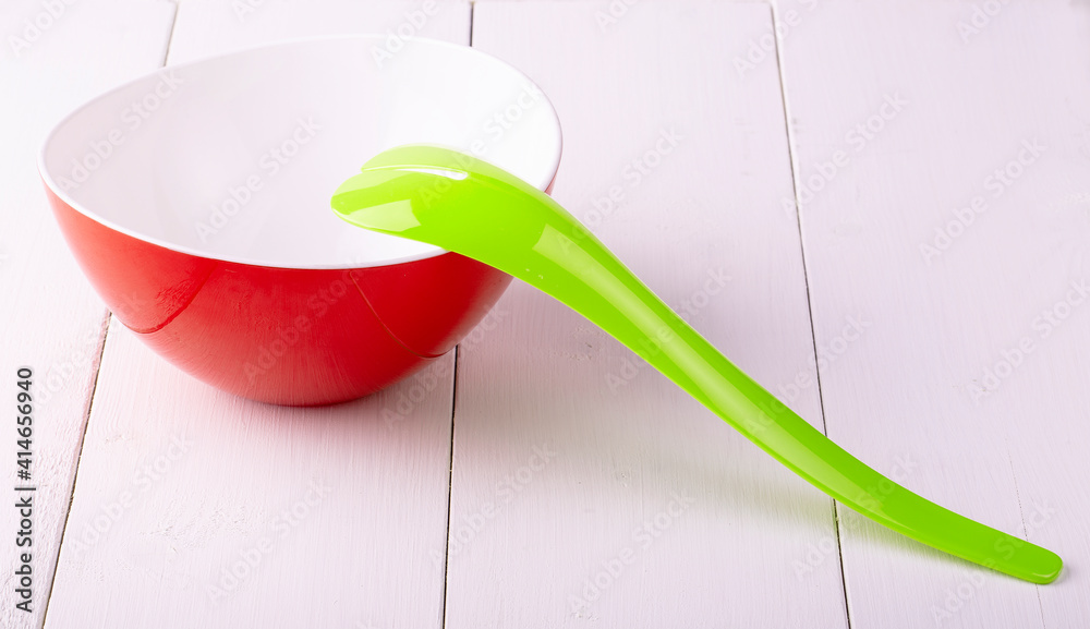 green plastic spoon salad on white wooden table green plastic spoon salad on white wooden table