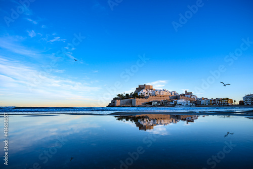 Beautiful village reflected on still water. Famous place Peniscola or Peñiscola on the Mediterranean. Templar Castle.