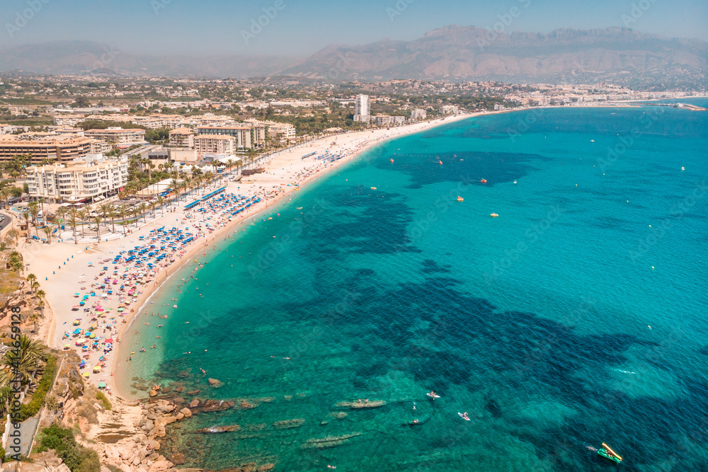 Spanish Mediterranean Sea Coast Landscape. Beach with turquoise water. Touristic sun and beach landmark in Playa del Albir, Comunidad Valenciana, Spain