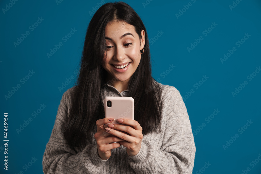 Happy beautiful asian girl smiling and using smartphone Happy beautiful asian girl smiling and using smartphone