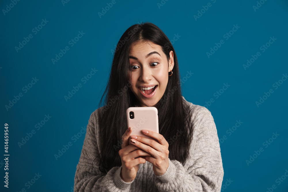Exited beautiful asian girl exclaiming while using smartphone Exited beautiful asian girl exclaiming while using smartphone