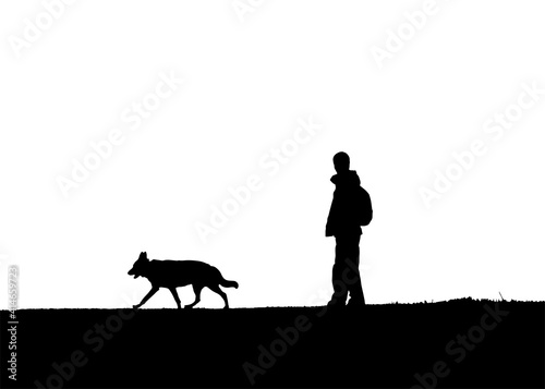 Silhouette of a man and a dog.