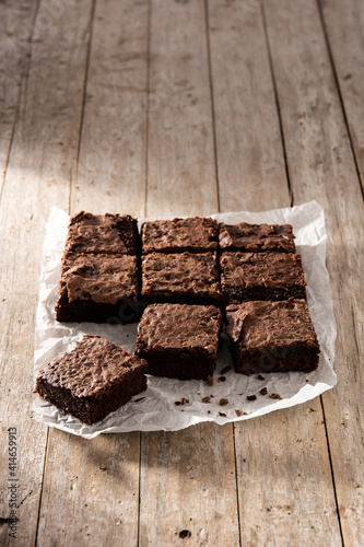 Homemade pieces of brownies on wooden table 