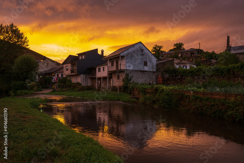 Colorful landscape in warm tones from yellow to red. A quiet river flows through out an isolated village at golden hour. Rihonor de Castilla, Zamora, Spain. photo