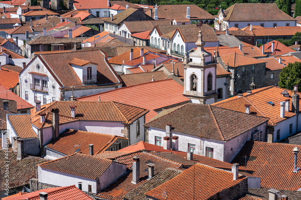 View of orange roofs and white small buildings in a picturesque town. Trancoso, Portugal.