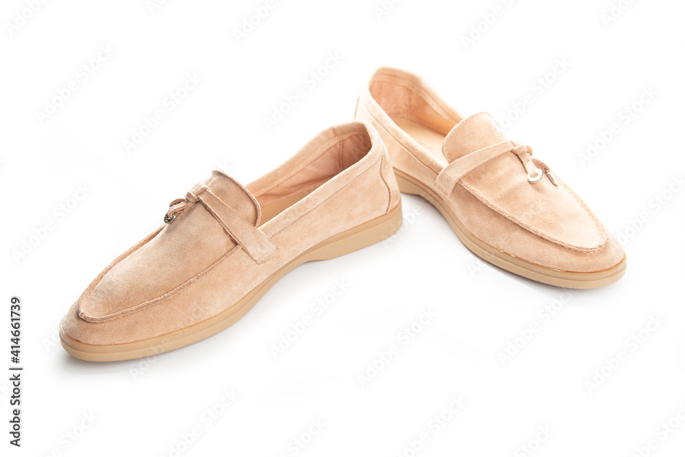 Pair of beige modern unisex loafers on white background Pair of beige modern unisex loafers on white background