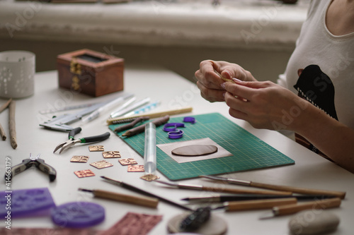 Craft jewelery making with professional tools. A handmade jeweler process, manufacture of jewellery. photo