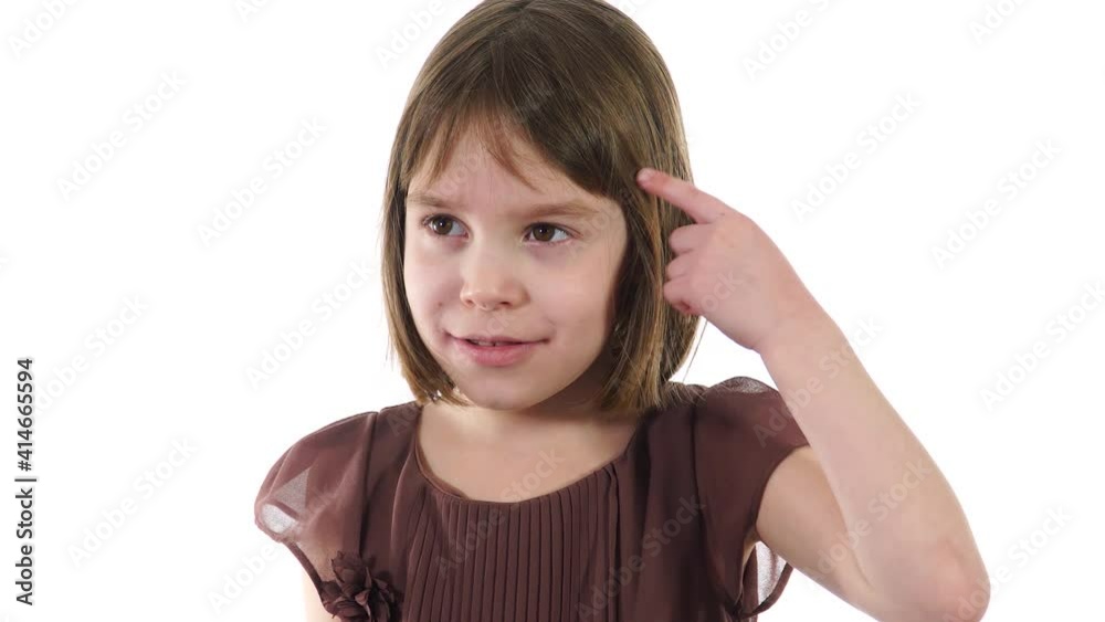 Blonde caucasian child show sign - you are crazy. Model's finger at her forehead and it's means that someone is crazy. Blonde caucasian child show sign - you are crazy. Model's finger at her forehead and it's means that someone is crazy.