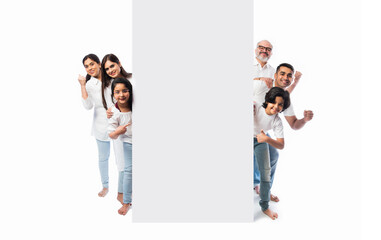 Indian happy family holding or presenting white board, wall or placard
