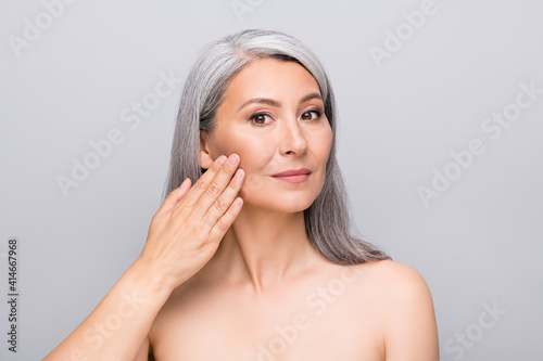 Portrait of optimistic nice long hair woman touch face without clothes isolated on light grey color background