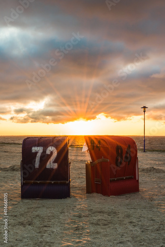 Strandkörbe an der Nordsee im Abendlicht, Neuharlingersiel, Ostfriesland, Deutschland photo