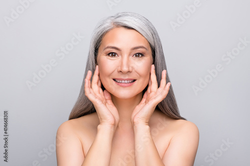 Portrait of optimistic nice long hair woman touch face without clothes isolated on light grey color background
