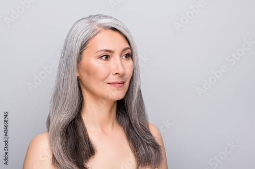 Profile side view portrait of attractive gray-haired lady healthy fresh skin copy space isolated over grey pastel color background
