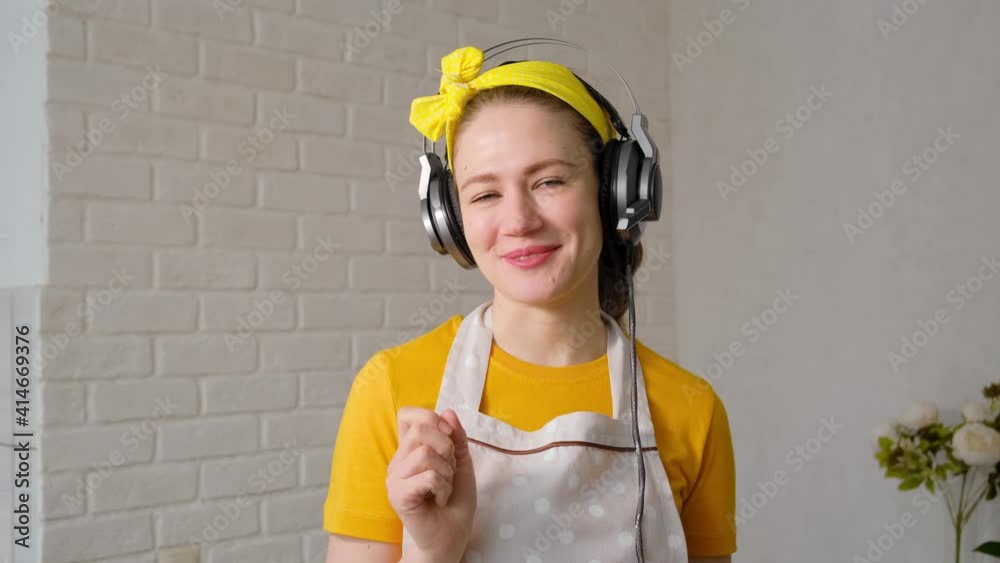 An attractive beautiful female blogger uses a smartphone to take selfies and record a video blog for her followers in a cafe and restaurant. A housewife wearing a yellow headband, a yellow T-shirt and An attractive beautiful female blogger uses a smartphone to take selfies and record a video blog for her followers in a cafe and restaurant. A housewife wearing a yellow headband, a yellow T-shirt and