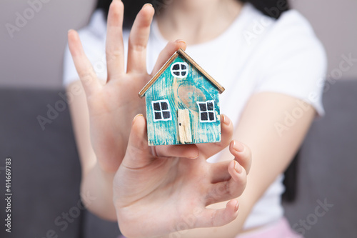 girl holding a model at home