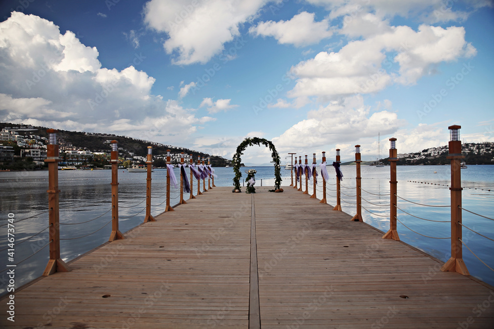 Wedding decoration at a pier by the beach with flowers