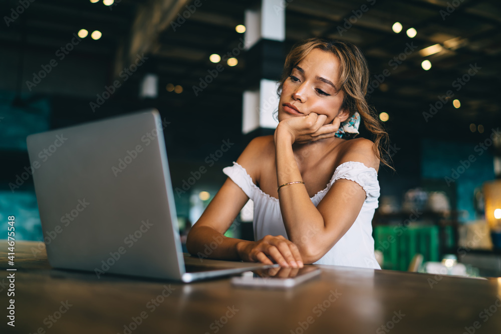 Unhappy woman sitting with laptop and smartphone Unhappy woman sitting with laptop and smartphone