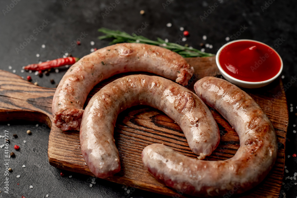 grilled sausages with spices on a stone background grilled sausages with spices on a stone background