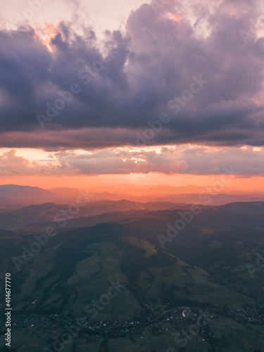 Carpathian mountains. Golden hour sunset landscape above and below rushing clouds over the mountains © Viachaslau