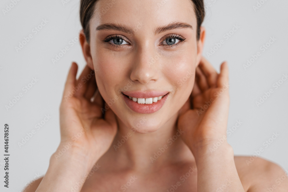 Happy shirtless girl smiling and looking at camera