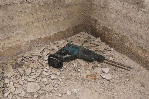 A perforator on the removed plaster on the floor.
