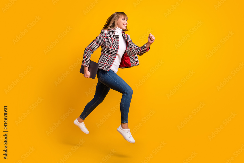 Full length profile photo of pretty carefree person running look empty space isolated on yellow color background Full length profile photo of pretty carefree person running look empty space isolated on yellow color background