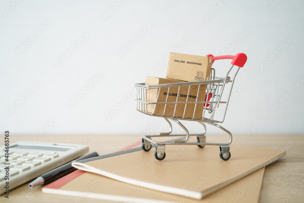 Online shopping with a shopping cart and shopping bags delivery service using as background shopping concept and delivery service concept with copy space  for your text or  design.